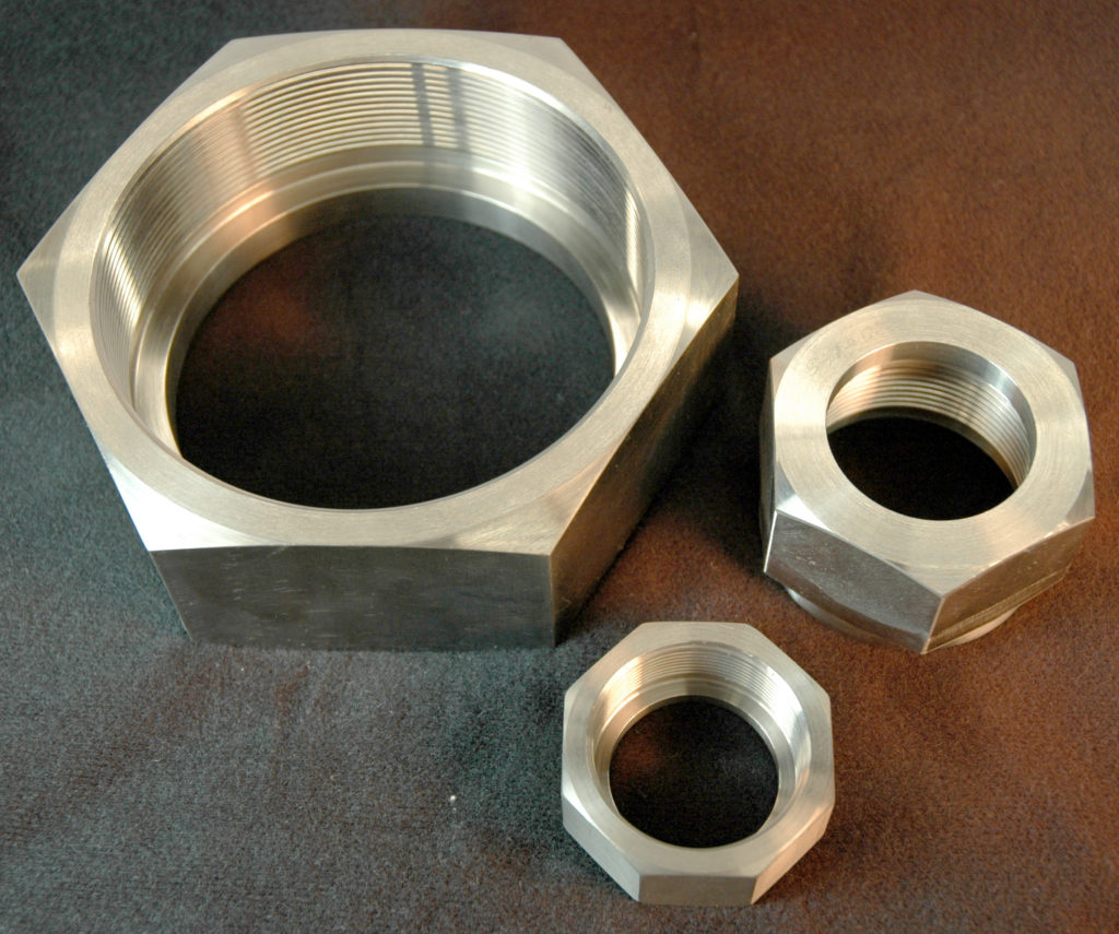 Three Hexagonal Metal Nuts with Threaded Interiors, Large, Medium, and Small